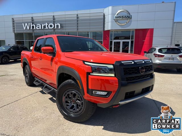 2025 Nissan Frontier PRO-4X in Afterburn Orange — front three-quarter view